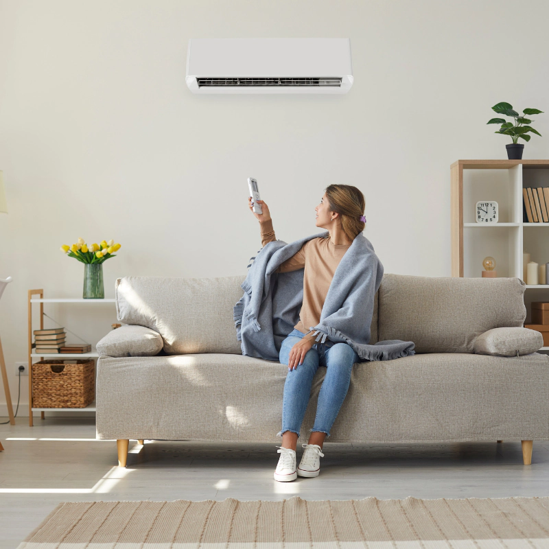 a person turning on the mini split unit